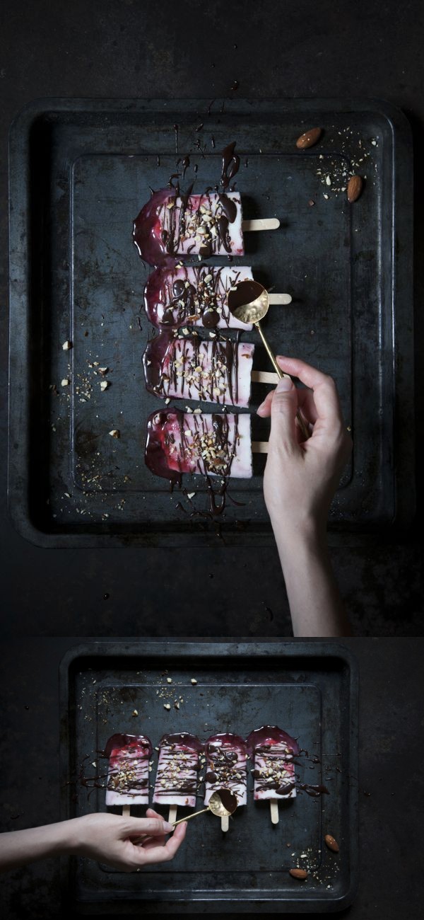 Creamy yogurt and cherry syrup popsicles with dark chocolate and salted roasted almonds