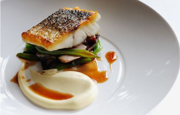 Escalope of wild sea bass with sautéed smoked bacon, red chicory, runner beans and red wine sauce