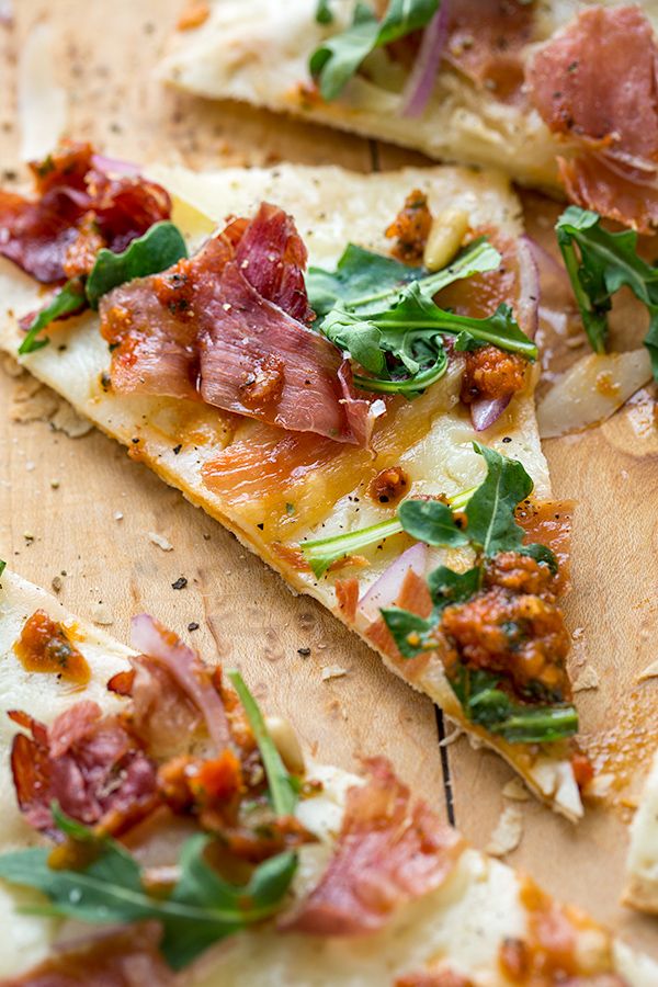 Crispy Prosciutto Flatbread Pizza with Arugula, Shaved Parmesan, and Sun-Dried Tomato Chutney