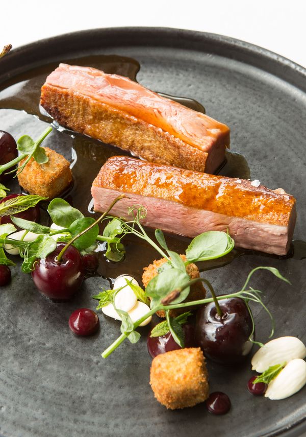 Roast duck breast and crispy leg croquettes with cherries and almonds