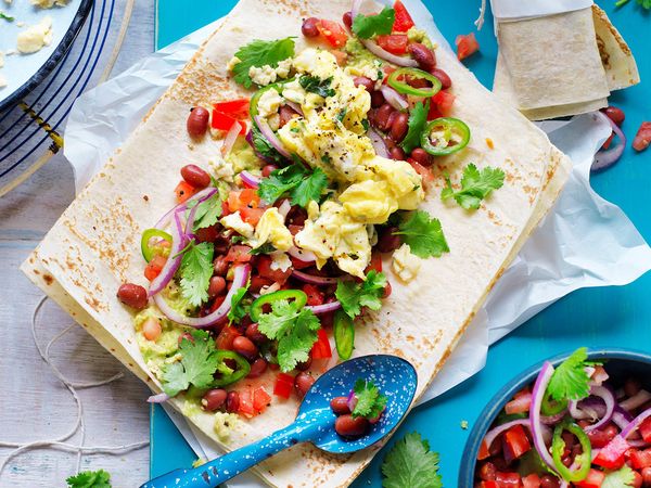 Scrambled eggs, smashed avocado and bean breakfast wrap