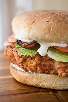 Spicy & Crispy Chicken Caesar Club with Melted Parmesan & Mozzarella Cheeses, Creamy Garlic-Parmesan Sauce, Bacon, Fresh Greens & Sliced Tomatoes, with Sea Salt Oven Fries