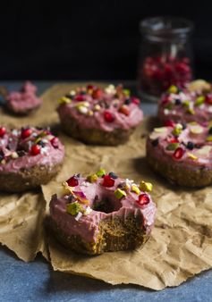 Raw vegan cinnamon donuts with a fruity pink frosting