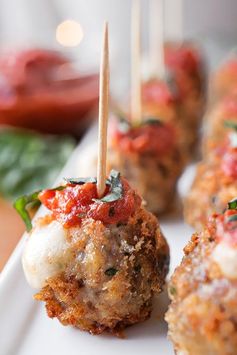 Crispy Caprese Meatballs Stuffed with Fresh Mozzarella, topped with Marinara and Fresh Basil