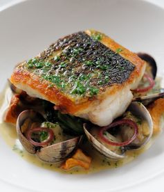 Pan-fried sea bass, butter spinach, clams, poached cod cheeks and fish sauce